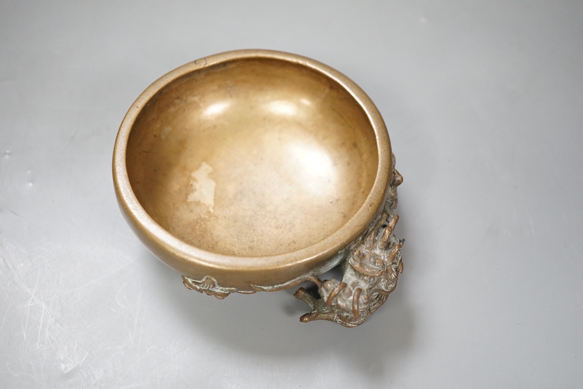 A Chinese or Japanese bronze ‘dragon’ dish, 13cm